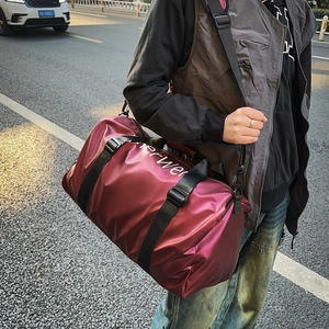Burgundy oxford cloth tote bag with black straps and lettering in urban setting