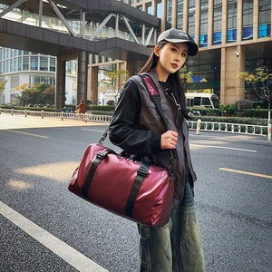 Waterproof burgundy oxford cloth tote travel bag with adjustable strap in outdoor setting