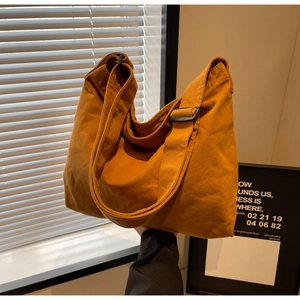 Detail of ginger canvas tote showing durable fabric texture and adjustable strap buckle