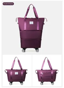 Detailed view of burgundy expandable oxford travel bag with wheels and luggage handle strap
