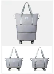 Detail view of foldable grey Oxford fabric travel bag with wheels and expansion zipper
