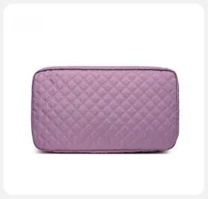 Detailed bottom view of purple quilted oxford fabric sports bag with diamond stitching
