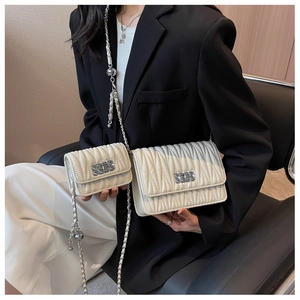 Detailed comparison of white quilted leather chain bags in medium and small sizes