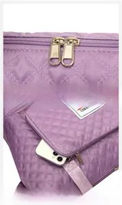 Detail of purple quilted fabric showing gold zippers and front pocket for smartphone