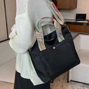 Black nylon tote bag with colorful floral jacquard wide strap for casual wear