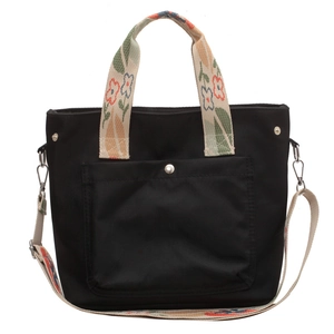 Versatile black nylon tote bag with floral pattern straps and adjustable shoulder strap