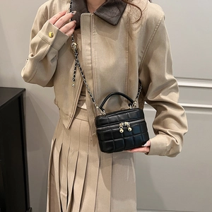 Chic black quilted bucket bag with golden chain and adjustable ball slider for women