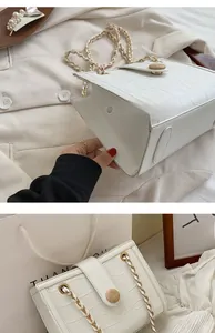 Detail of white crocodile pattern shoulder bag with gold chain and round wood buckle