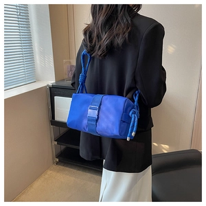 Detail of Klein blue nylon crossbody bag with thick rope shoulder strap and buckle closure