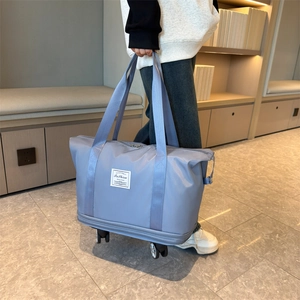 Large Oxford fabric travel bag with wheels and durable handles in light grey blue