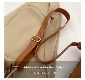Detail of the adjustable brown leather strap with silver buckle on the tote bag