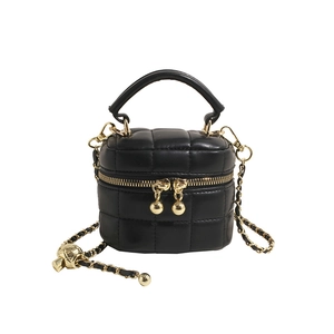 Chic black quilted bucket bag with golden chain strap and leather handle