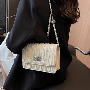 Elegant white quilted chain crossbody bag with V-shaped texture for modern women