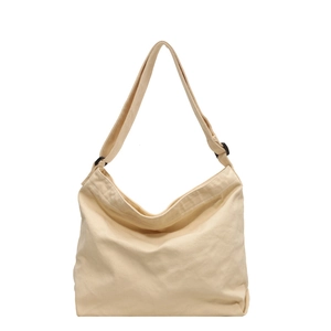 Minimalist cream canvas hobo bag with adjustable black buckle strap and large capacity