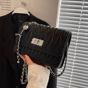 Chic black wrinkled texture crossbody bag with silver lock and chain strap on shoulder