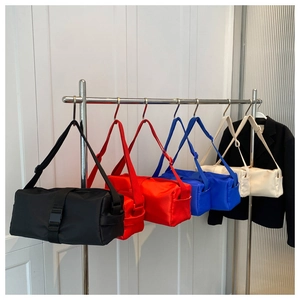 Selection of colorful nylon cylinder crossbody bags with adjustable shoulder straps and buckles
