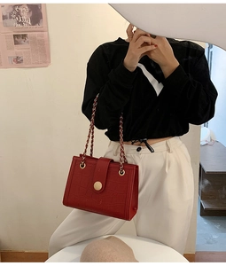 Red crocodile texture wedding bag with gold chain strap shown on model's shoulder