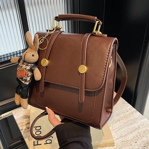 Vintage dark brown leather backpack for women with top handle and cute bunny charm