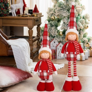 Detail of Christmas elf dolls in red and white outfits with plaid hats for home decor