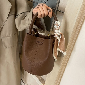 Retro brown lychee leather bucket bag for women with decorative silk scarf and handle