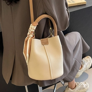 Retro beige bucket bag in lychee leather with silk scarf and brown top handle strap