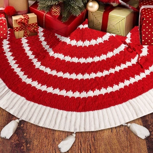 Close-up of red and white knitted wave pattern Christmas tree skirt with tassel details