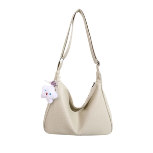 Cream hobo tote bag with lychee texture and cloud plush charm shown on white backdrop