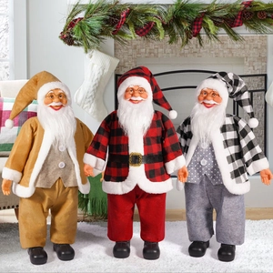 Three 24-inch standing Santa Claus dolls in gold and plaid outfits by a fireplace