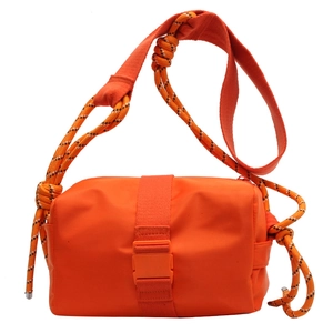 Orange nylon crossbody bag with chunky woven rope strap and plastic buckle design