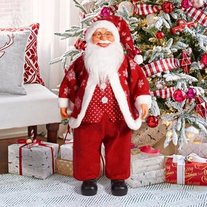 Close-up of a 24-inch standing Santa doll with gold glasses in a cozy festive setting