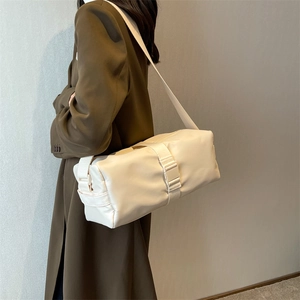 Minimalist off-white nylon crossbody bag with adjustable wide strap and plastic buckle