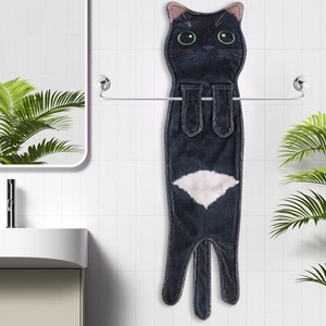 Detail of cute black cat hand towel hanging on a bathroom rack with realistic embroidery