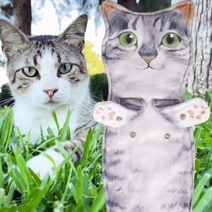 Macro detail of tabby cat hand towel featuring realistic print and metal snap buttons