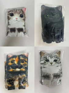 Close-up of four pairs of socks with realistic 3D cat face prints in clear packaging