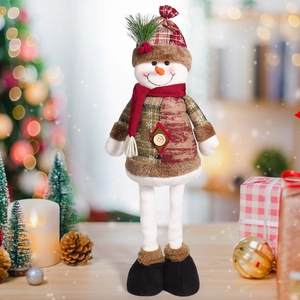Detail of plush Christmas snowman figurine with long legs on a festive wooden table