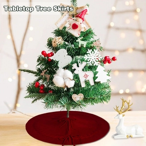 Detail of red knitted tabletop tree skirt with woven texture and bow tie closure