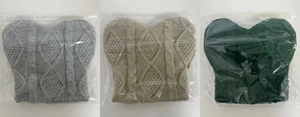 Detail of cable knit winter hats in grey, beige, and green with ribbed texture