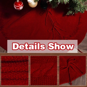 Detail of red knitted Christmas tree skirt featuring cable knit patterns and bow ties