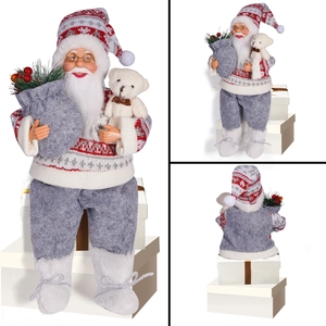Detail of sitting Santa figurine holding a small white plush bear and gift bag