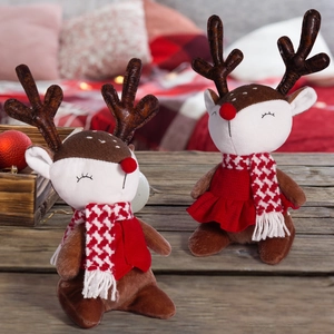 Close-up of cute Christmas reindeer plush toys with scarves in a festive setting