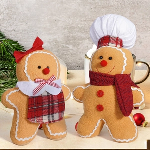 Charming plush gingerbread man and woman figurines with festive scarf and plaid skirt