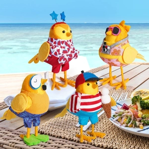 Detailed view of four felt beach birds with summer outfits and miniature accessories