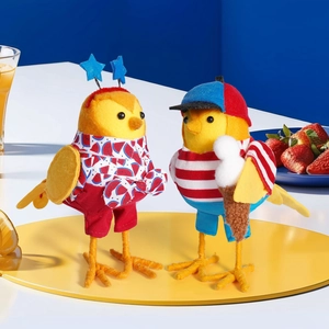 Close-up of bird ornaments in summer outfits with watermelon prints and ice cream