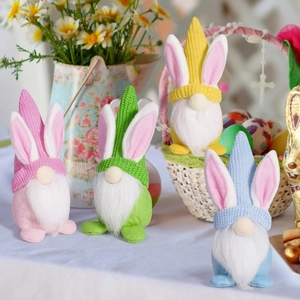 Close-up of four colorful knit Easter gnomes with bunny ears and white beards