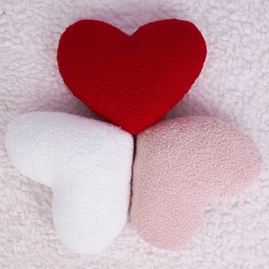 Set of red, white, and pink heart-shaped boucle throw pillows for home decor