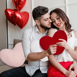 Detail of soft heart-shaped teddy fleece pillows in red, pink and white colors