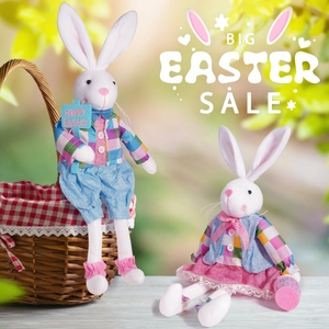 Detailed view of plush Easter bunnies in plaid outfits with a festive basket on a wooden table
