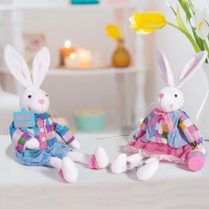 Detail of Easter bunny plush pair with plaid outfits and Happy Easter signage