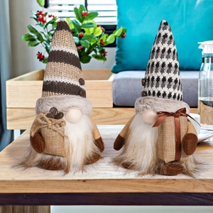 Detail of coffee gnome plush dolls with striped knitted hats and holiday gift boxes