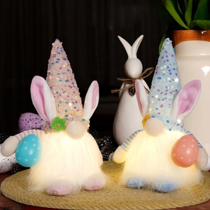 Detail of glowing Easter gnomes with sequined hats and bunny ears in warm LED light